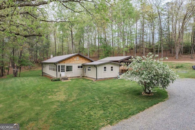 18131 Morganton Hwy, Morganton, GA 30560 - view of front of home featuring board and batten siding, a front lawn, a chimney, and entry steps