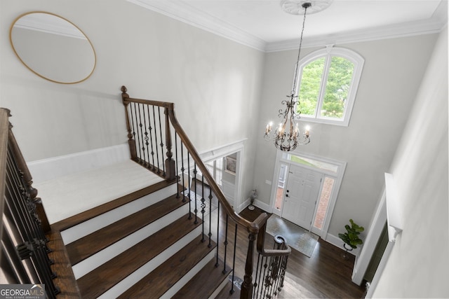 2743 Long Grove Dr, Marietta, GA 30062 - foyer entrance with wood finished floors, a chandelier, baseboards, stairs, and crown molding