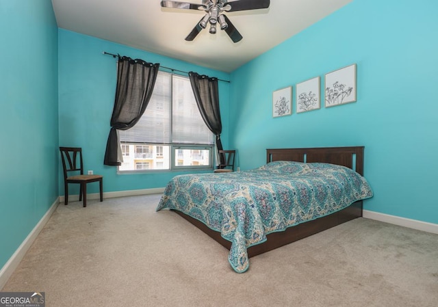 carpeted bedroom with baseboards and a ceiling fan