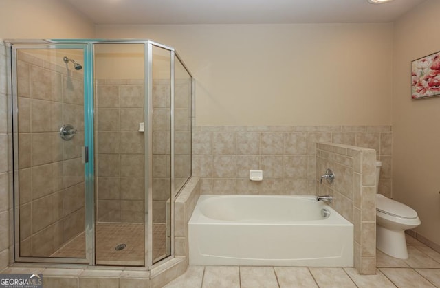 full bathroom with tile patterned flooring, a shower stall, toilet, and a bath