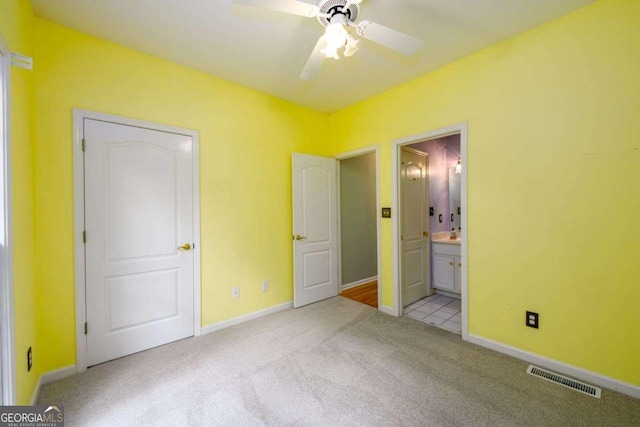 2430 Harbin Springs Cv, Dacula, GA 30019 - unfurnished bedroom with light carpet, connected bathroom, baseboards, and a ceiling fan