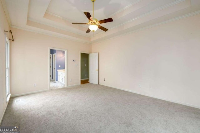 2430 Harbin Springs Cv, Dacula, GA 30019 - unfurnished bedroom featuring a tray ceiling, crown molding, carpet, and baseboards
