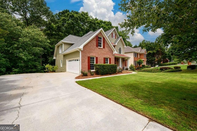 2430 Harbin Springs Cv, Dacula, GA 30019 - view of front of house featuring brick siding, a front yard, driveway, and an attached garage