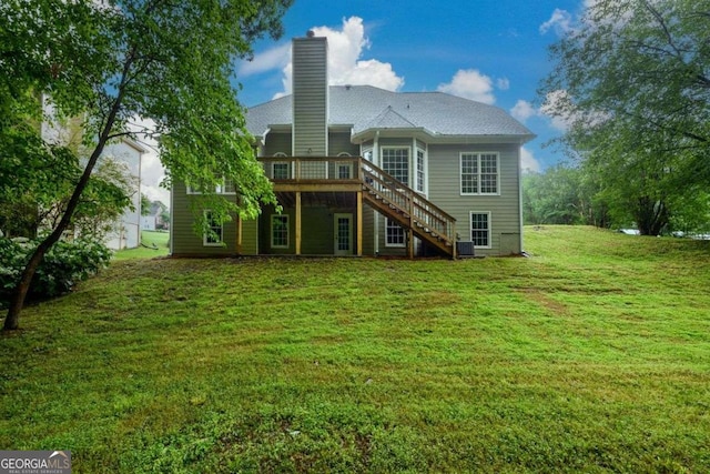 2430 Harbin Springs Cv, Dacula, GA 30019 - back of house with stairs, a deck, a chimney, a lawn, and central AC unit