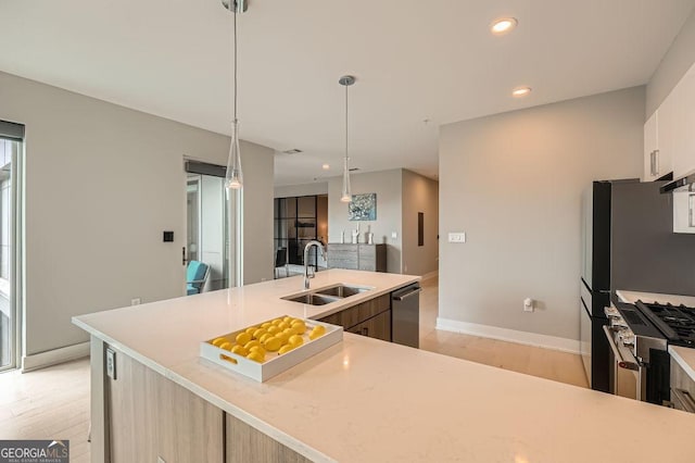 775 Juniper St NE Unit 612, Atlanta, GA 30308 - kitchen featuring a sink, appliances with stainless steel finishes, light wood finished floors, light countertops, and recessed lighting