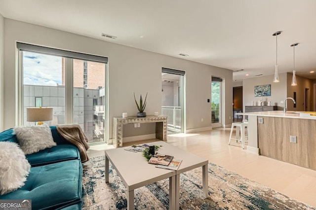 775 Juniper St NE Unit 612, Atlanta, GA 30308 - living area featuring healthy amount of natural light, light wood-type flooring, and baseboards