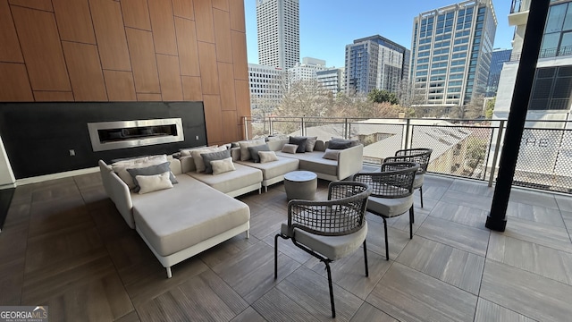 775 Juniper St NE Unit 612, Atlanta, GA 30308 - living room featuring a city view, expansive windows, and a glass covered fireplace