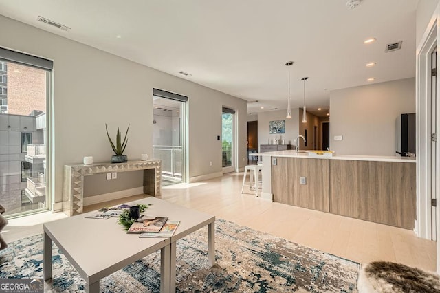 775 Juniper St NE Unit 612, Atlanta, GA 30308 - living room with light wood-type flooring, baseboards, and recessed lighting