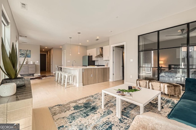 775 Juniper St NE Unit 612, Atlanta, GA 30308 - living area featuring light wood-style flooring, recessed lighting, and baseboards