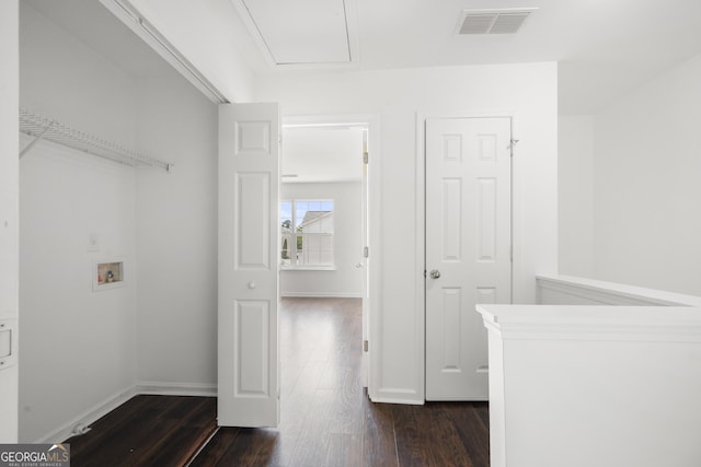 laundry area featuring dark wood-type flooring, hookup for a washing machine, and baseboards