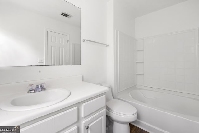 bathroom with vanity, toilet, wood finished floors, and tub / shower combination