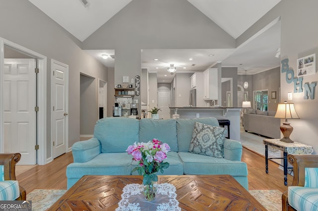 living area featuring light wood-style flooring, high vaulted ceiling, baseboards, and recessed lighting
