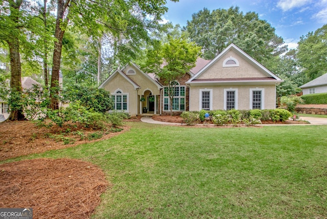 view of front of house featuring a front yard and stucco siding