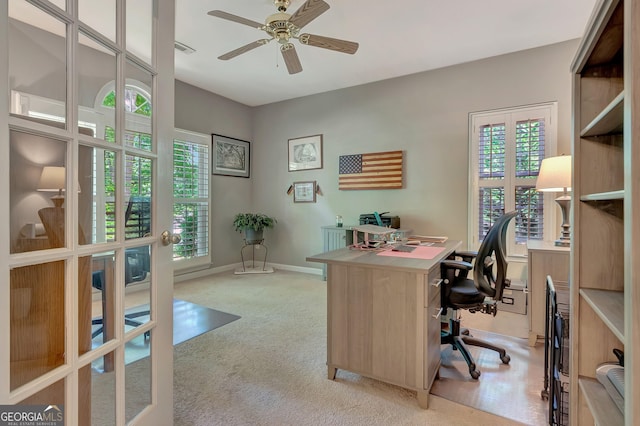 office area with ceiling fan, light carpet, and baseboards
