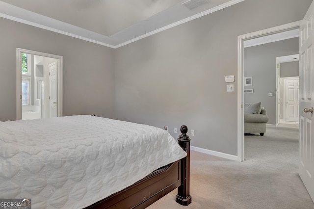 bedroom with carpet floors, ornamental molding, baseboards, and connected bathroom