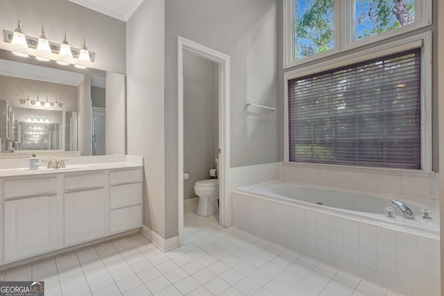 bathroom with tile patterned flooring, a bath, toilet, vanity, and crown molding