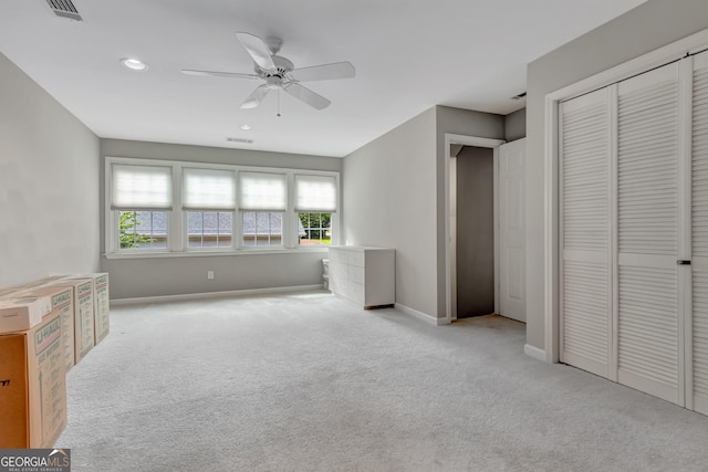unfurnished bedroom featuring carpet flooring, baseboards, recessed lighting, a closet, and a ceiling fan