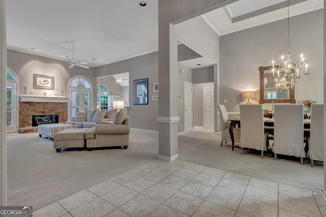 living room with light carpet, light tile patterned floors, a ceiling fan, crown molding, and baseboards