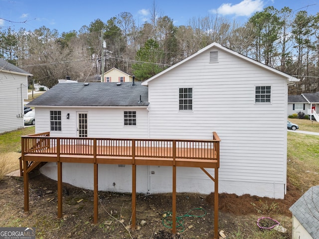 back of property featuring a wooden deck and a shingled roof