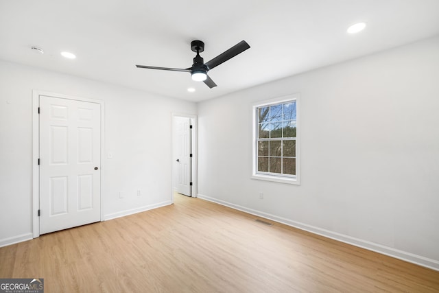 unfurnished bedroom with light wood finished floors, baseboards, recessed lighting, and a ceiling fan