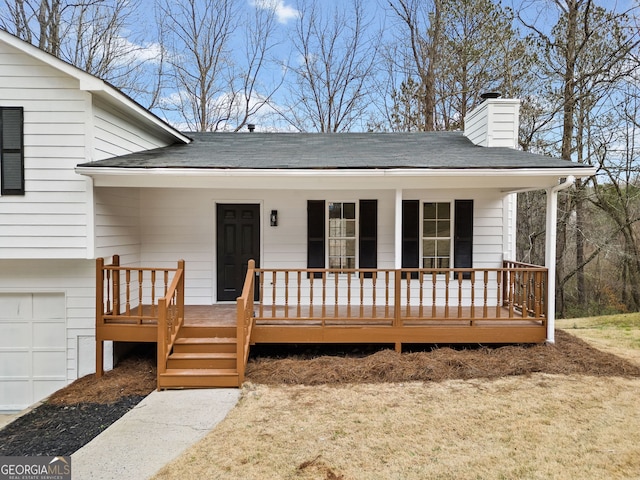 view of front of house featuring a chimney, roof with shingles, a porch, and a garage