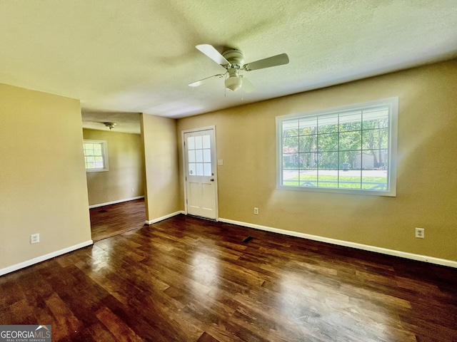 spare room featuring baseboards, a ceiling fan, and wood finished floors