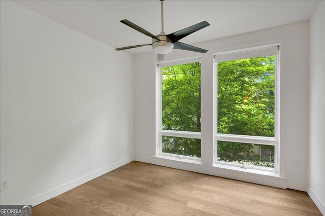 867 Peachtree St NE Unit 202, Atlanta, GA 30308 - empty room featuring a ceiling fan, wood finished floors, and baseboards