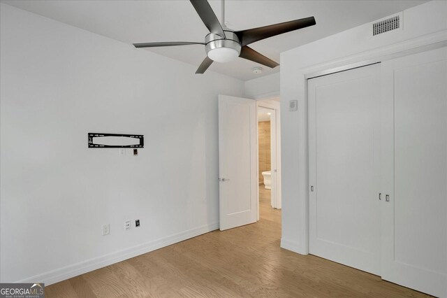 867 Peachtree St NE Unit 202, Atlanta, GA 30308 - unfurnished bedroom featuring wood finished floors, a closet, baseboards, and a ceiling fan