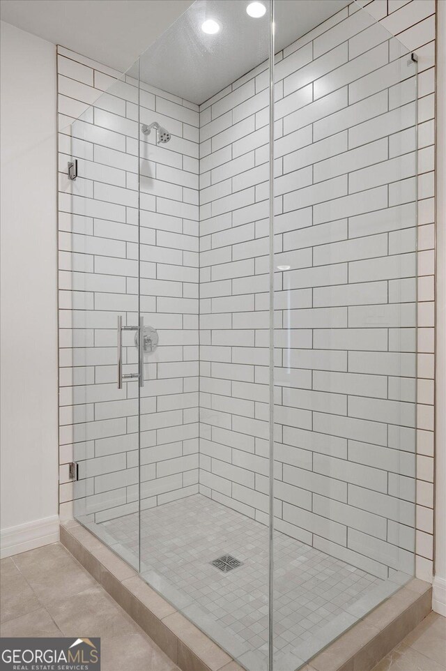 867 Peachtree St NE Unit 202, Atlanta, GA 30308 - full bath with a stall shower, baseboards, and tile patterned flooring