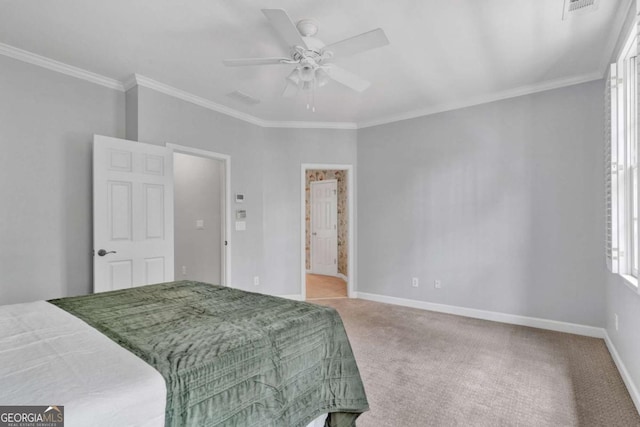 bedroom featuring carpet flooring, ornamental molding, baseboards, ceiling fan, and connected bathroom