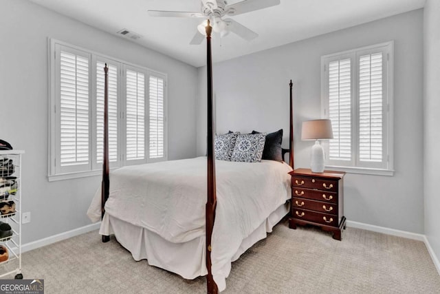 bedroom featuring multiple windows, carpet flooring, and baseboards