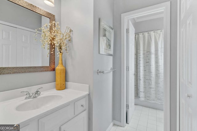 full bath featuring tile patterned flooring, vanity, curtained shower, and baseboards