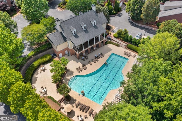 aerial view of property and surrounding area featuring a pool area