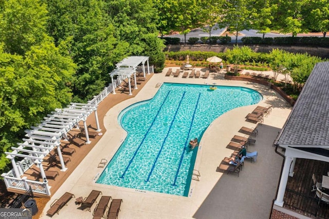 community pool with a pergola, a patio area, and stairs