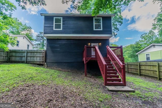 233 Clayton St, Fairburn, GA 30213 - back of house with a fenced backyard and stairway