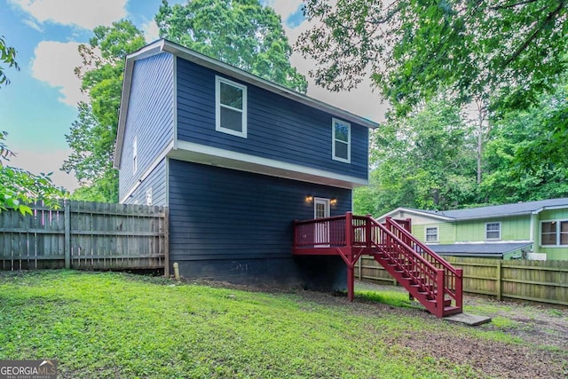 233 Clayton St, Fairburn, GA 30213 - back of house with stairway, a fenced backyard, and a deck