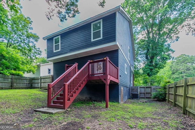 233 Clayton St, Fairburn, GA 30213 - back of property with a fenced backyard, a deck, and stairs
