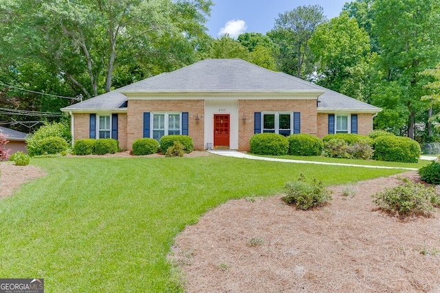 402 Johannah Pl SW, Lilburn, GA 30047 - view of front facade with a front yard, brick siding, and a shingled roof