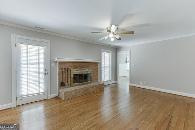 402 Johannah Pl SW, Lilburn, GA 30047 - unfurnished living room with ceiling fan, light wood finished floors, crown molding, a brick fireplace, and baseboards