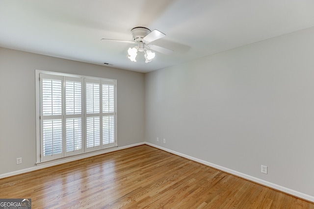 402 Johannah Pl SW, Lilburn, GA 30047 - spare room featuring light wood finished floors, baseboards, and a ceiling fan