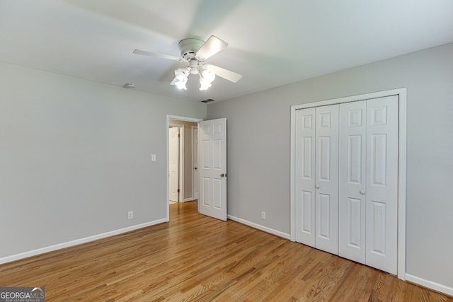 402 Johannah Pl SW, Lilburn, GA 30047 - unfurnished bedroom featuring light wood-style flooring, baseboards, a closet, and a ceiling fan