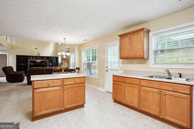 4549 Clarks Creek Ter, Ellenwood, GA 30294 - kitchen featuring a sink, a chandelier, light countertops, pendant lighting, and a textured ceiling