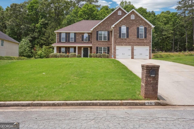4549 Clarks Creek Ter, Ellenwood, GA 30294 - colonial house featuring driveway, an attached garage, a front lawn, and brick siding