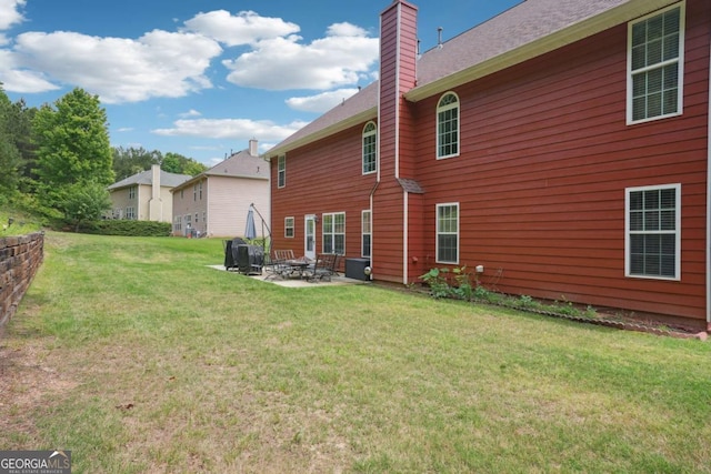 4549 Clarks Creek Ter, Ellenwood, GA 30294 - back of house with a patio, a chimney, and a yard