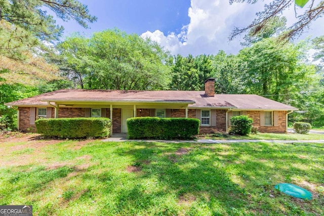 1296 Carman Ct SE, Conyers, GA 30013 - ranch-style house featuring a chimney, a front lawn, and brick siding