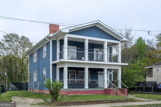 117 Joseph E Lowery Blvd NW, Atlanta, GA 30314 - view of front of house with a balcony, covered porch, a chimney, and fence