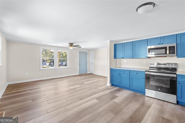 610 Ash Ln, Monroe, GA 30655 - kitchen with appliances with stainless steel finishes, blue cabinets, light wood-style flooring, and ceiling fan