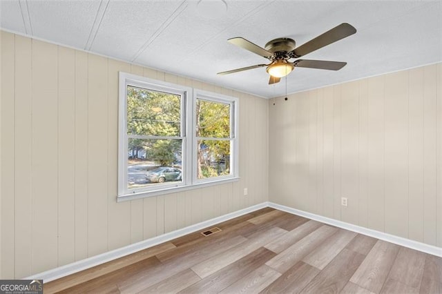 610 Ash Ln, Monroe, GA 30655 - spare room with wood finished floors, a ceiling fan, baseboards, and a textured ceiling