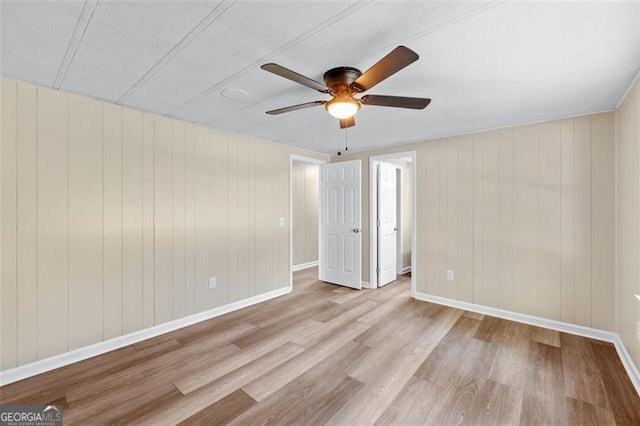 610 Ash Ln, Monroe, GA 30655 - unfurnished bedroom with wood finished floors, baseboards, and ceiling fan