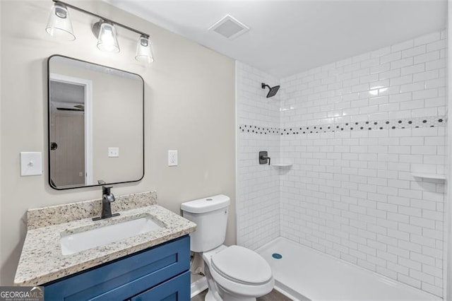 610 Ash Ln, Monroe, GA 30655 - full bathroom with toilet, a tile shower, and vanity